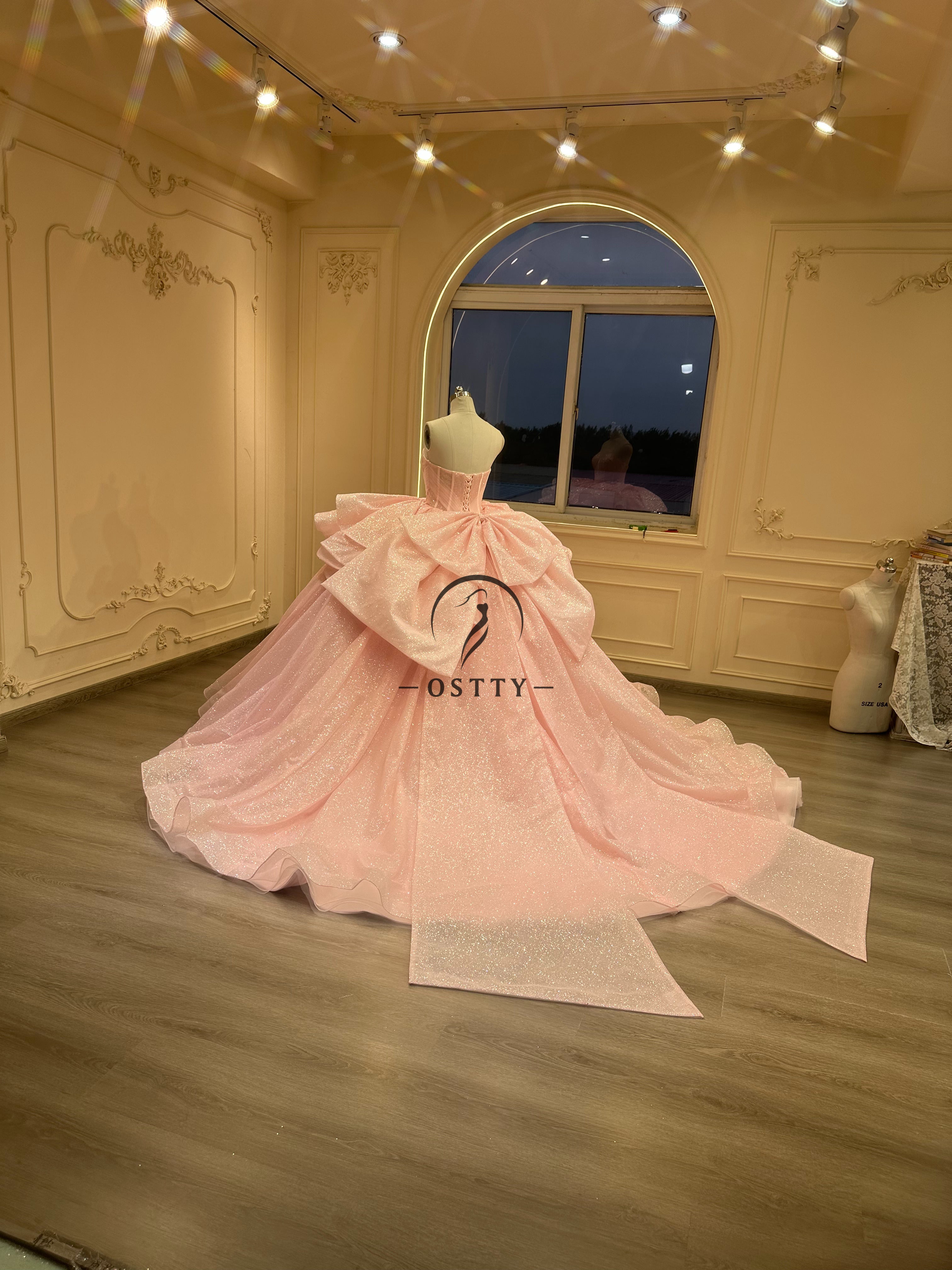 Ostty Soft Pink Glitter Quinceañera Dress with Layered Ruffle Skirt and Bow Back OST-QN049-25 (Wholesale)